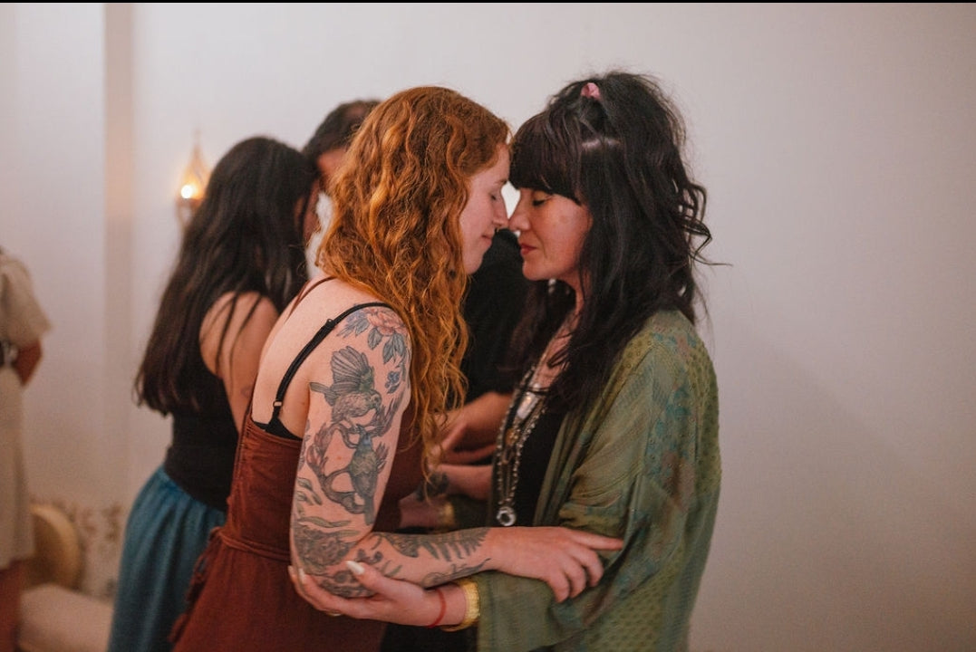 Two women embracing in ceremony