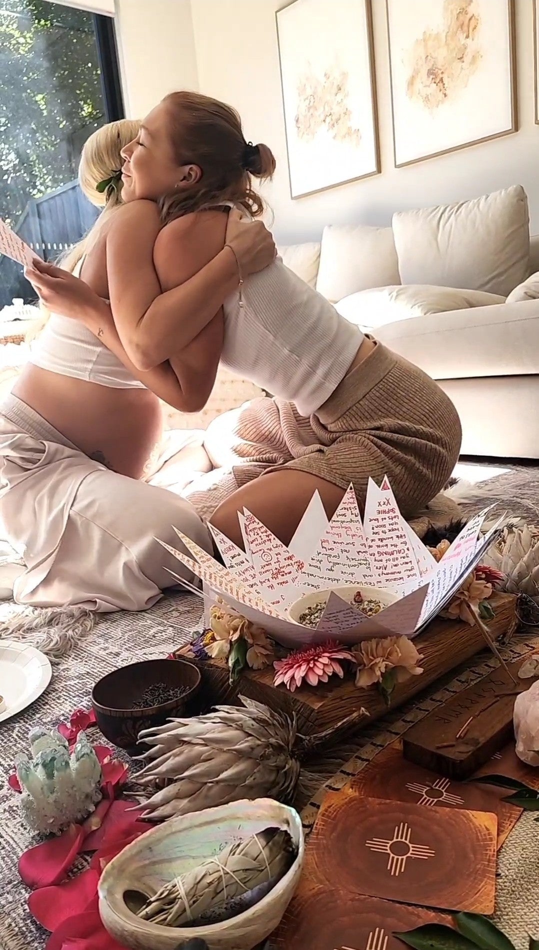 A friend shares her birth message with a hug