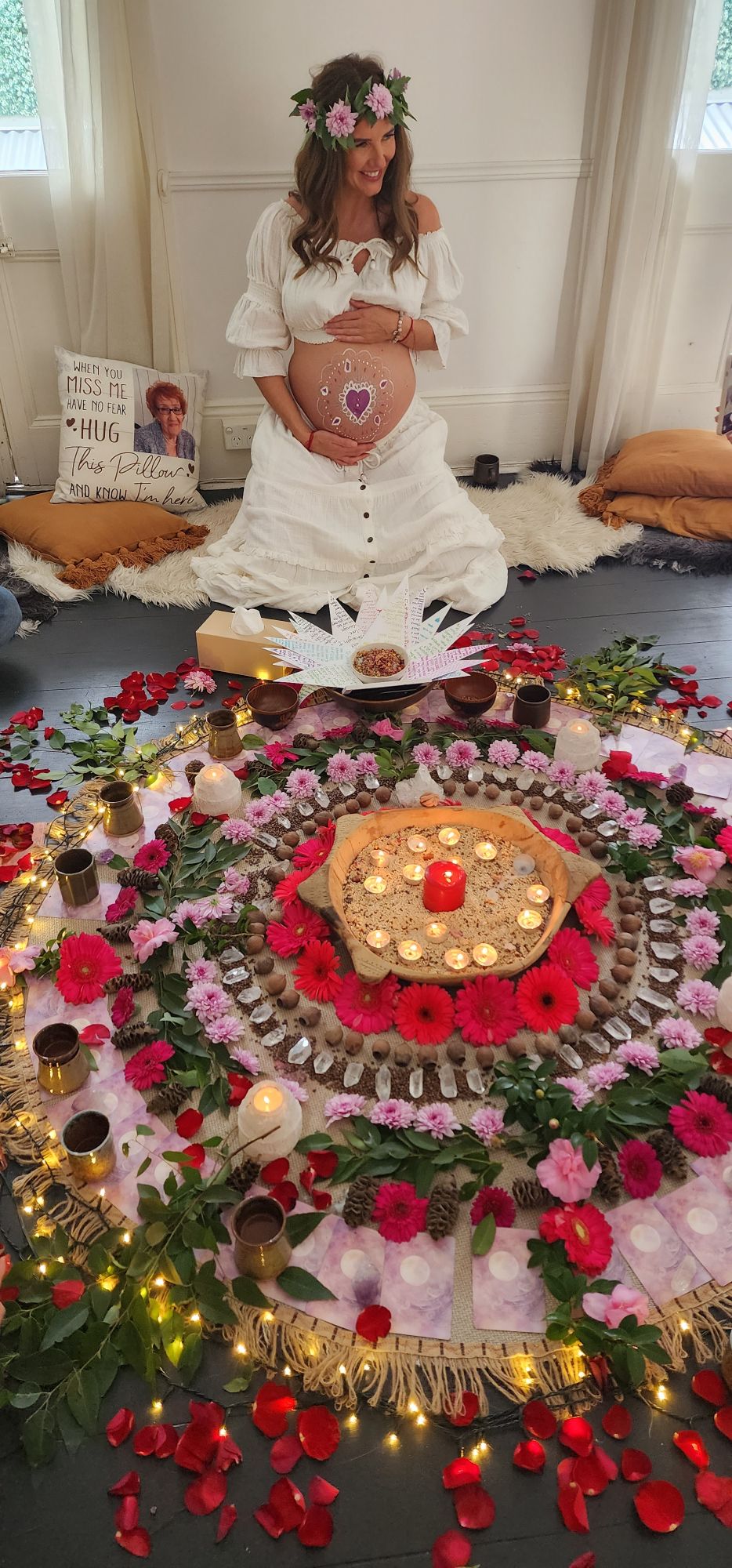 Mother to be in a flower crown before her earth altar