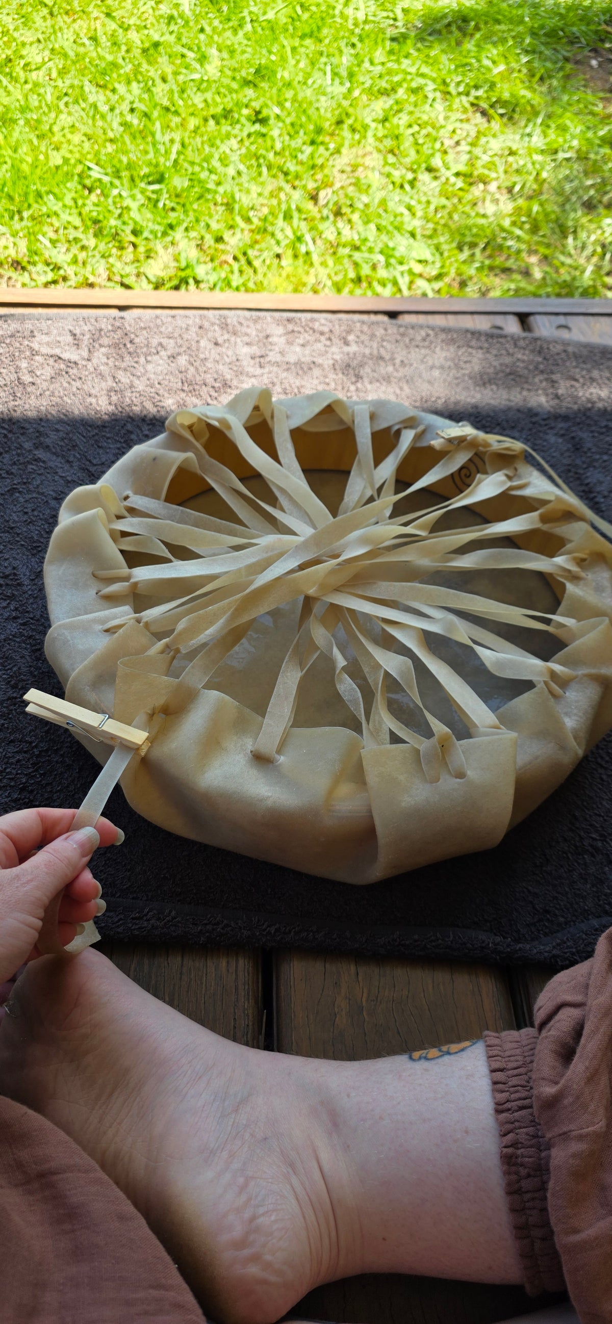 Holding a newly birthed medicine drum in the garden